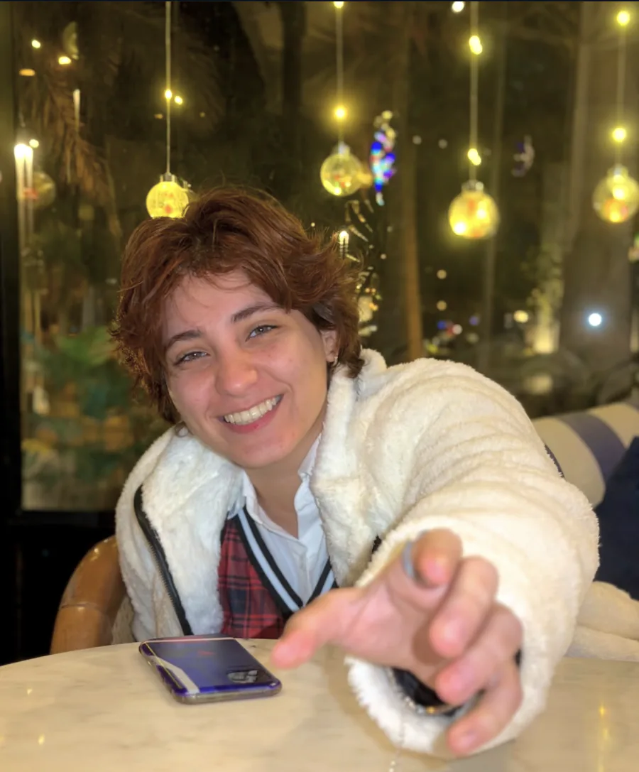 Teema Bashar Alakel laughing at a cafe